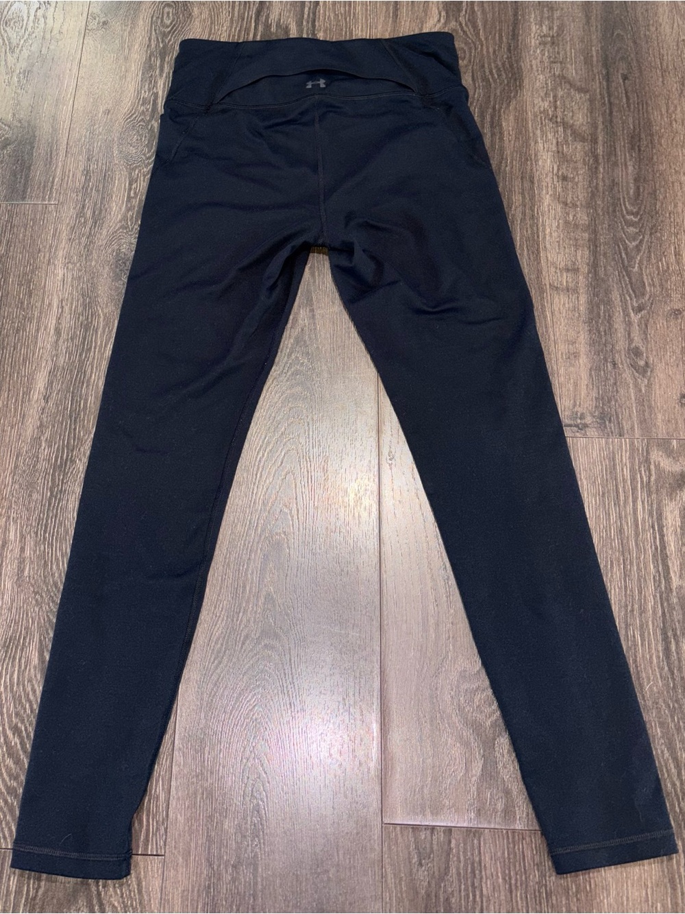 Under Armour Black women’s Athletic Leggings w/small pocket where logo is.